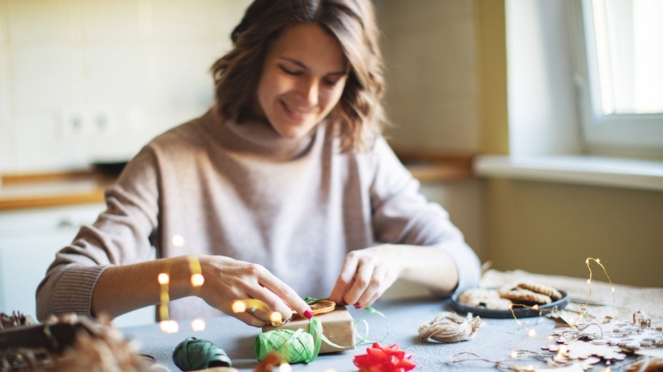 Woman wrapping Christmas gifts