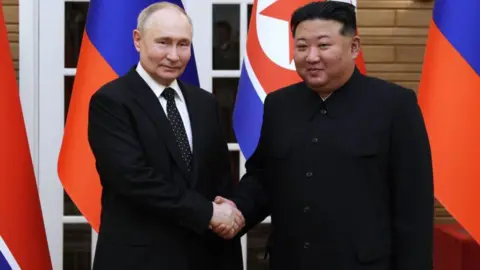 Getty Images Kim Jong Un (right) and Vladimir Putin shake hands after a welcoming ceremony at Kim Il Sung Square in Pyongyang on June 19, 2024