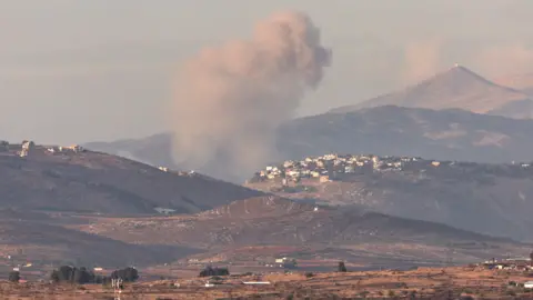 EPA Smoke rises following an Israeli strike on the border village of Khiam in southern Lebanon, as seen from northern Israel (17 November 2024)