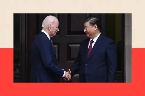 Getty Images Joe Biden greets Chinese President Xi Jinping. They both wear suits and shake hands.