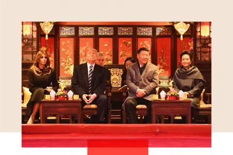 Getty Images President Donald Trump looks up as he sits beside First Lady Melania Trump and China's President Xi Jinping and his wife Peng Liyuan during a tour of the Forbidden City in Beijing on November