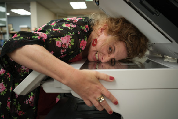 Flinley Craddick’s MD Hannah Howard (Felicity Ward) gets up close with the photocopier in The Office Australia.