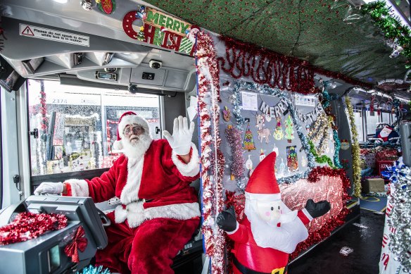 Bus driver Ian Rowsell behind the wheel of his best-decorated bus of the 2023 Christmas season.