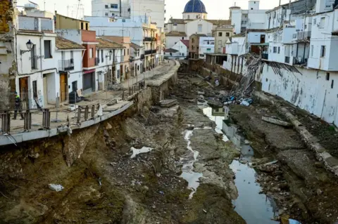 JOSE JORDAN/AFP Flood-damaged homes line the river in Chiva, Spain