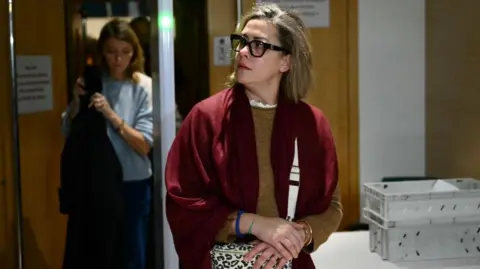 CHRISTOPHE SIMON/AFP Gisèle Pelicot's daughter Caroline Darian gave evidence in court on Wednesday. Here she is leaving the court clasping her bag