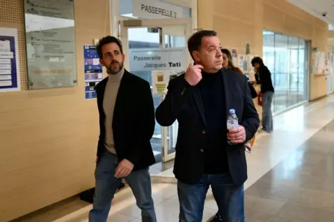 Getty Images Florian, the youngest sibling of the family (L), and his brother David in a corridor during the trial