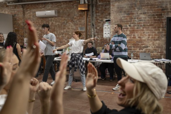 Producer and choreographer Mackenzie Dunn (centre) and writer Maverick Newman (back left) in rehearsals.