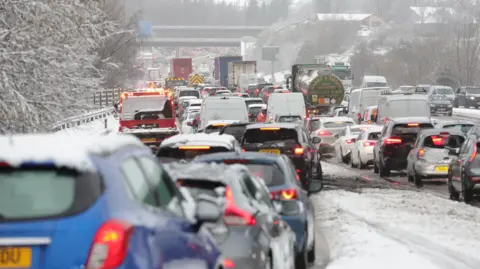 PA Media Traffic at a standstill in bad weather conditions on the M80 near Castlecary, North Lanarkshire, Scotland