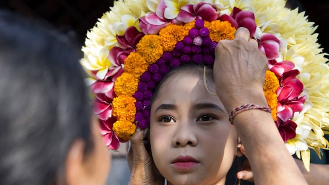 A day later, Wahyuni's mother Kadek Krisni has picked fresh flowers from their garden and prepared an elaborate headdress while her daughter was in school. Today is Rejang Pucuk day, one of the most sacred forms of Rejang. It was routine as usual in the morning. The latter half of the day will be spent in the temple. This is life in Bali. (Image: AP Photo)