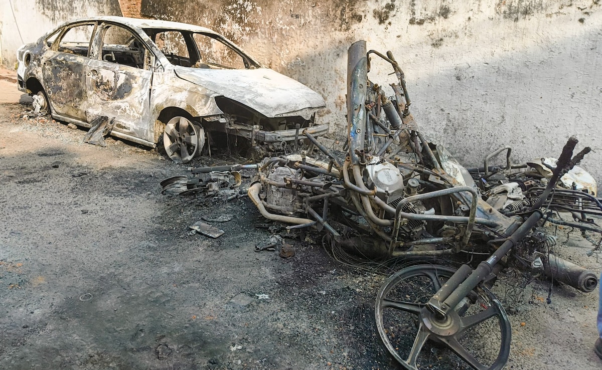 Charred remains of vehicles after violence erupted during the survey of the Jama Masjid in Sambhal on Sunday