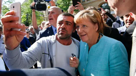 Reuters Angela Merkel taking a selfie with a Syrian refugee