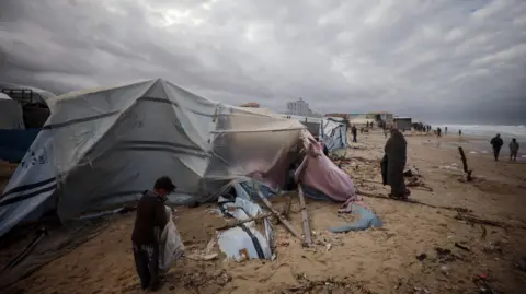 Displaced Palestinians living in makeshift shelters on Gaza's Mediterranean coast near Deir al-Balah, central Gaza