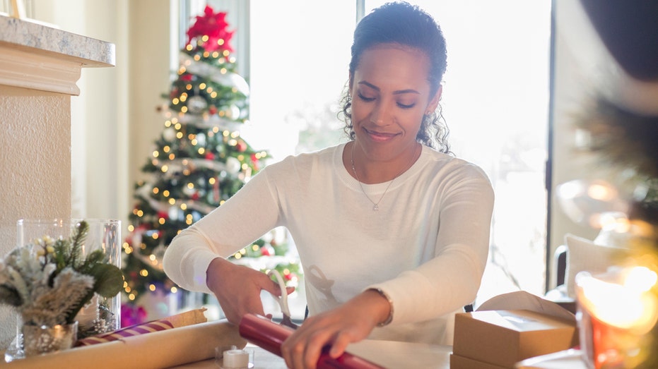 Woman cutting wrapping paper