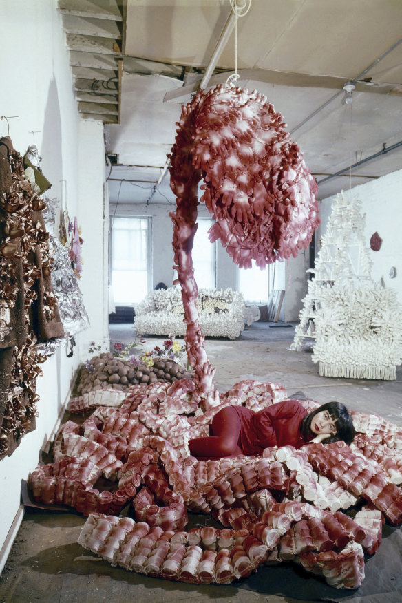 Yayoi Kusama in her New York studio, c. 1965, with her sculpture My Flower Bed, 1962.