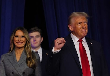 Republican presidential nominee and former U.S. President Donald Trump makes a fist as he takes the stage with his wife Melania and son Barron to address supporters at his rally, at the Palm Beach County Convention Center in West Palm Beach, Florida, U.S., November 6, 2024. REUTERS/Brian Snyder