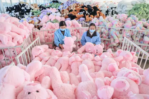 AFP Employees work on a production line of stuffed teddy bears 