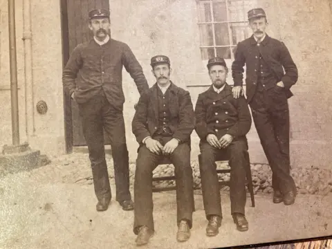 Jane Murray An old photograph of four lighthouse keepers outside the Corsewall Lighthouse in 1892.