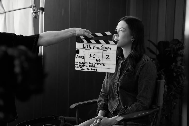 Jenny Lee-Gilmore sits in a chair during production of Little Miss Sleepy.