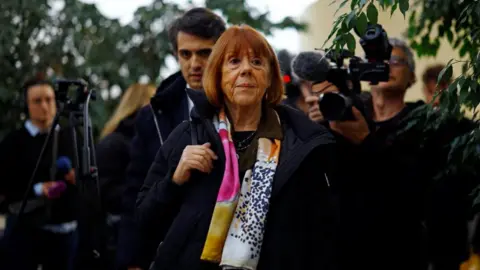 Reuters Gisèle Pelicot walks into court in Avignon to give her final day of evidence in the mass rape trial of 51 men