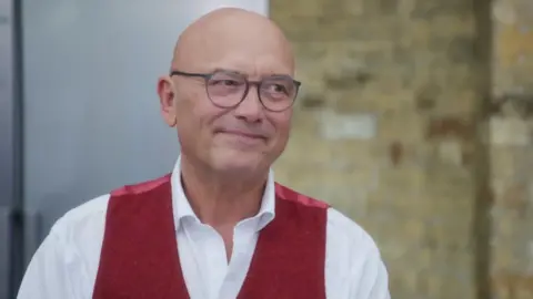 BBC/Shine TV A picture of MasterChef host Gregg Wallace in a white shirt and red waistcoat