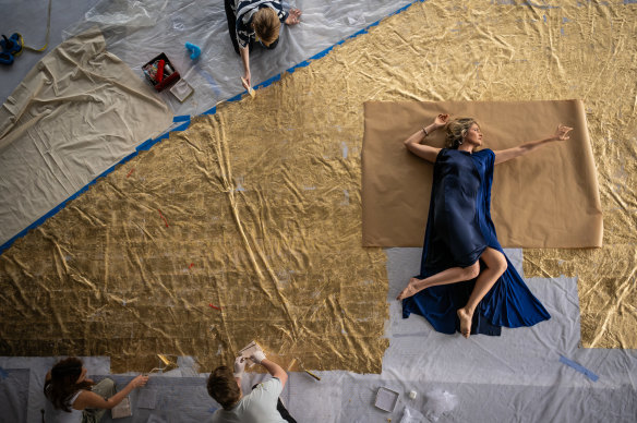 Soprano Samantha Clarke poses on part of the set being prepared for the upcoming Julius Caesar.