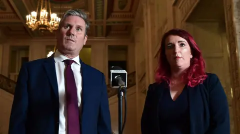 Getty Images Sir Keir Starmer in a suit and tie standing next to Louise Haigh, who has red hair and is wearing a dark suit