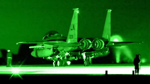 Contributed/BBC The rear of a USAF F-15 fighter jet photographed at night, in a green night-sight hue