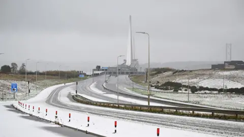 Reuters The pillars of the Queensferry Crossing in the distance with an empty motorway covered with snow in the foreground