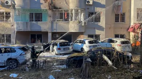 EPA Ukrainian rescuers work at the site of a missile strike in a residential area in Odesa, south-western Ukraine, 18 November 2024,