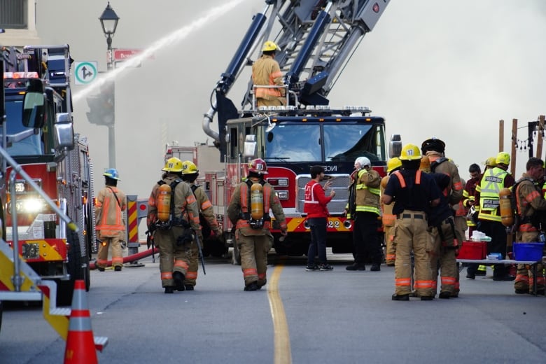 Firefighters work to extinguish a large fire.