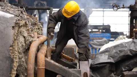 BBC/Joe Phua A worker tries to fix a power plant in Ukraine