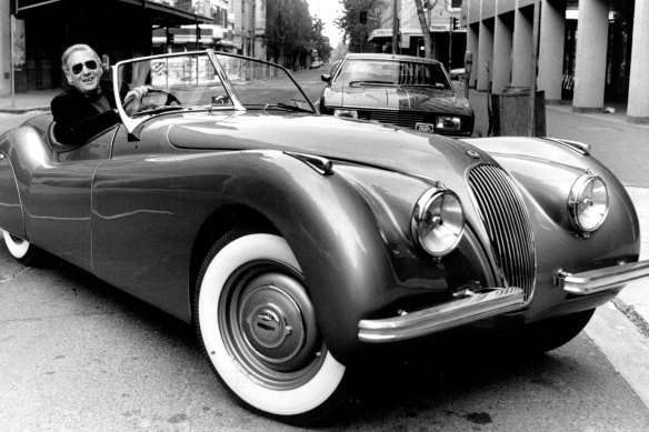 Driving his 1949 Jaguar XK120 and wearing a Superman jumper, Laws returns to 2GB in June 1986, after his fifth operation. 