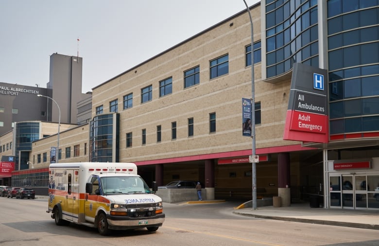 An ambulance drives past Health Sciences Centre in Winnipeg.