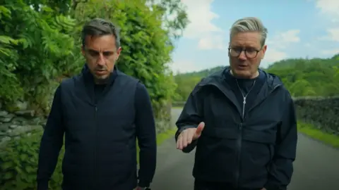 Keir Starmer/YouTube/PA Wire Gary Neville and Sir Keir Starmer walking down a rural road.