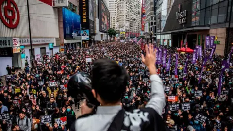 Getty Images People take part in a pro-democracy march in Hong Kong on January 1, 2020