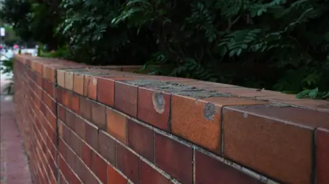 BBC Chinese / Lok Lee Pockmarked wall at Hong Kong Polytechnic University