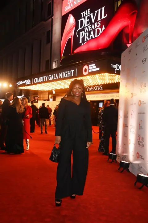 Alan Chapman/Dave Benett/Getty Images Clara Amfo wears all black outside Dominion Theatre for The Devil Wears Prada: The Musical charity gala night