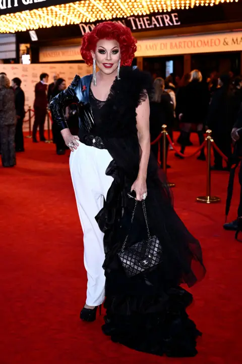 Gareth Cattermole/Getty Images La Voix posing on red carpet at the Dominion Theatre, London