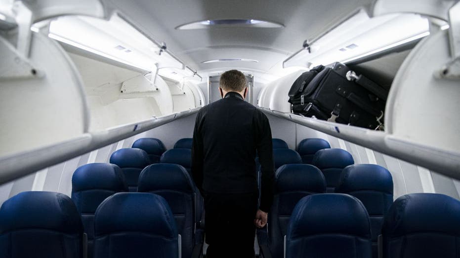 a Delta flight attendant inspecting an empty plane