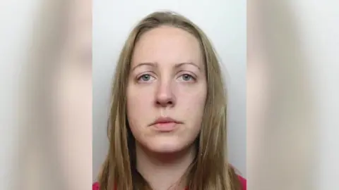 Cheshire Police A mugshot of Lucy Letby - a young woman with long blond hair. She has a serious expression and is wearing a red shirt