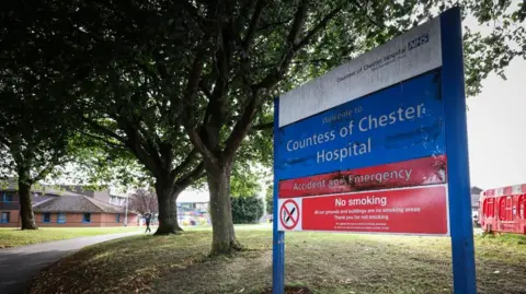 EPA A blue sign in front of a footpath reads 'Countess of Chester Hospital' 