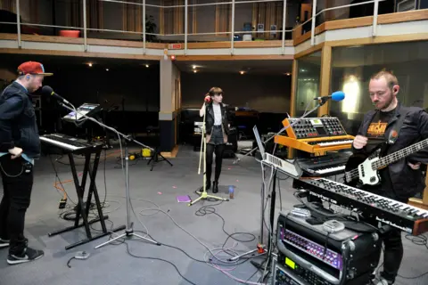 Chvrches playing at the BBC Maida Vale studios in 2013 (L-R): Martin Doherty, Lauren Mayberry and Iain Cook