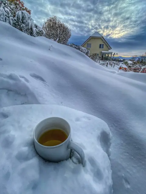 Rajitha Cruz A mug of tea in a snowy landscape