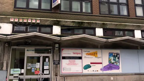 Hastings Commons An image of the front of Rock House in 2014 when it was rundown with damp and dirt visible on the bricks and roof over the front door.