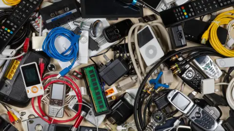 Getty A large pile of old electronic good likes phones and wires