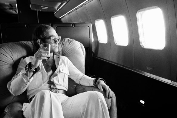 Elton John on his private plane, known as the Starship, during his 1974 tour. 