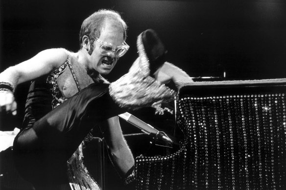 Elton performing in one of his classic 70s jumpsuits.