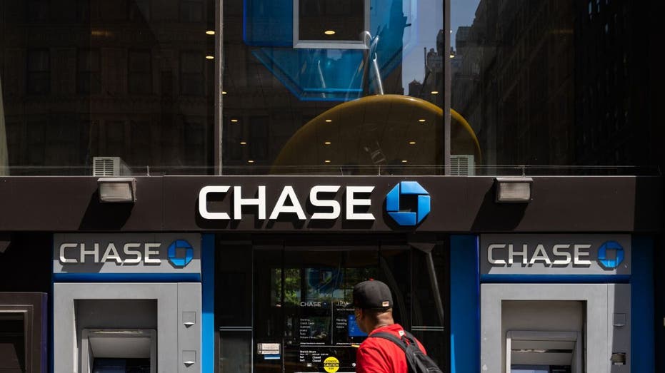 a person walking by Chase ATMs