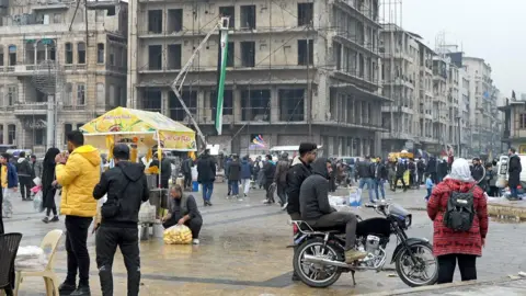 People milling around Aleppo square.