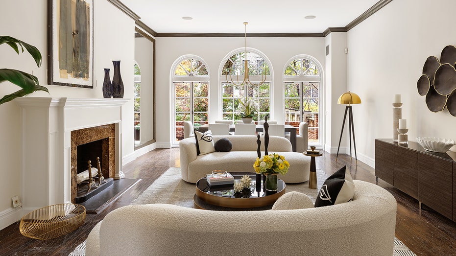 The parlor level of the home features a formal living area with arched windows and a fireplace.